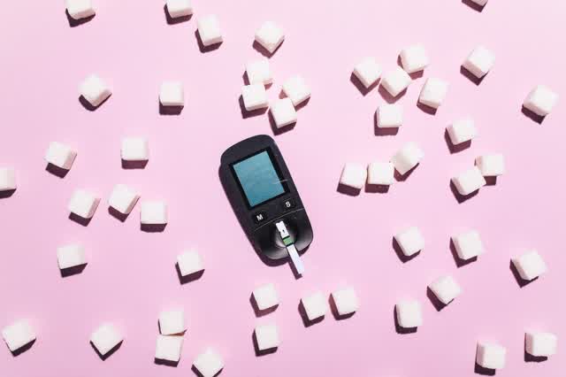 Glucose meter surrounded by sugar cubes